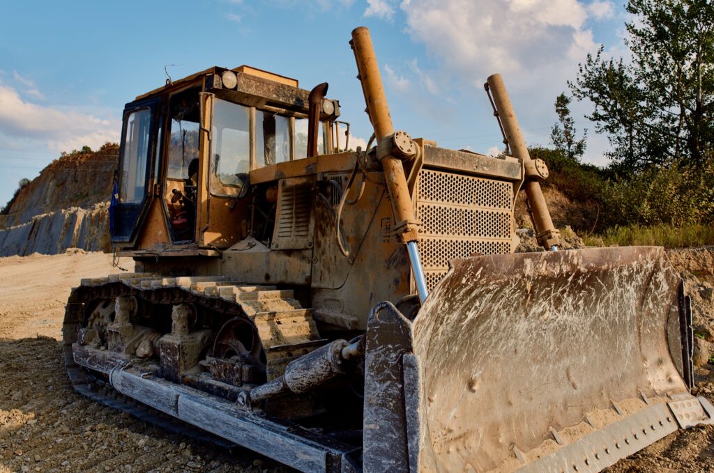 truck digging ground for construction excavator gravel sand trees blue sky