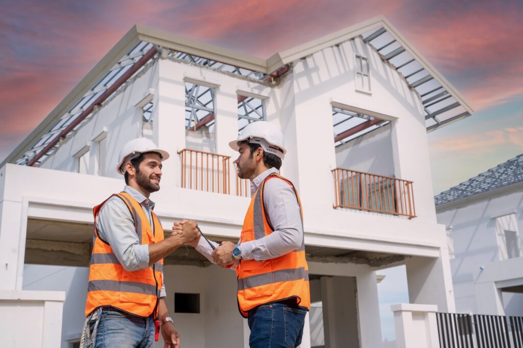 Architect shaking hands engineer team builder in renovation site.